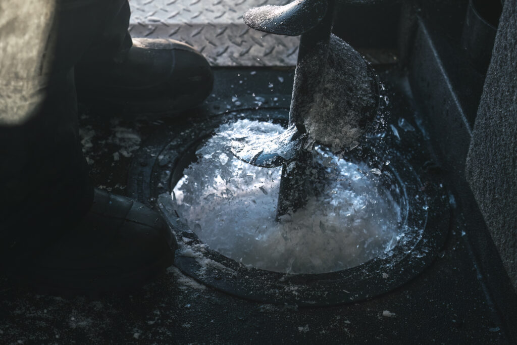 ice fishing manitoba drilling hole hecla island